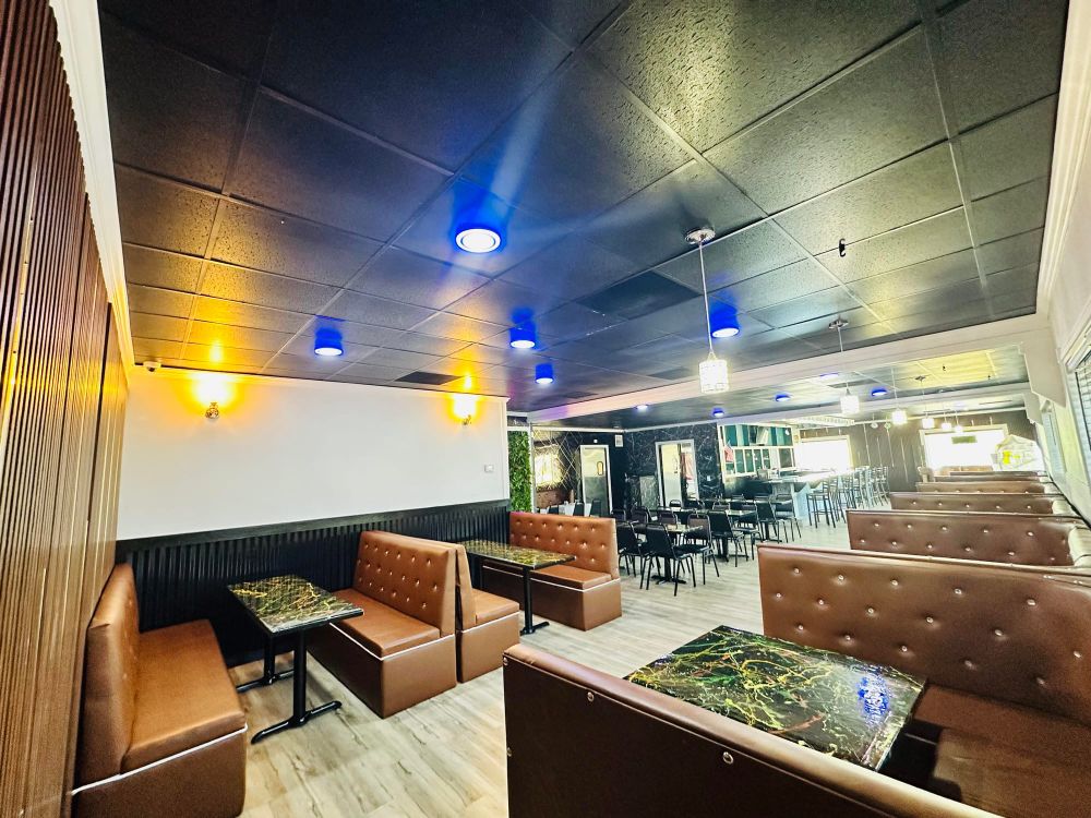 Brown tufted booths and marble tables