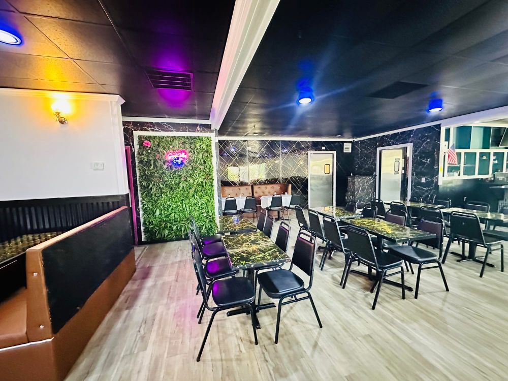 Main dining room with brown booths and pendant lighting